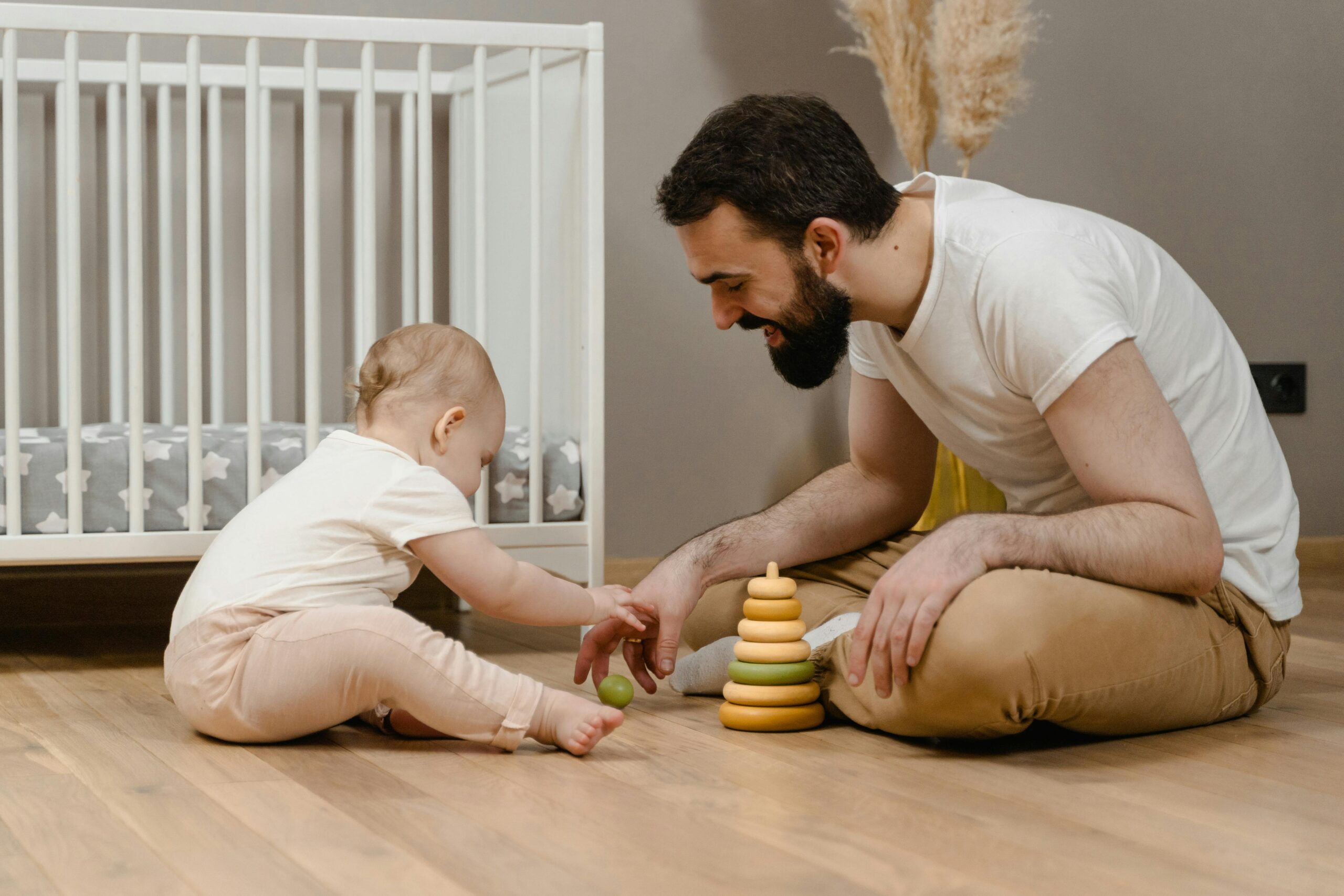 Child engaged in sensory play at home with a parent, representing calm and supportive early development.